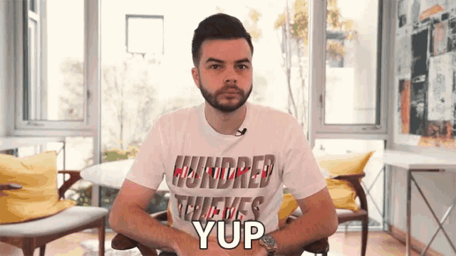 a man wearing a hundred thieves t-shirt says yup