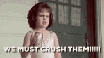 a little girl is holding a can of soda and saying `` we must crush them !!! '' .