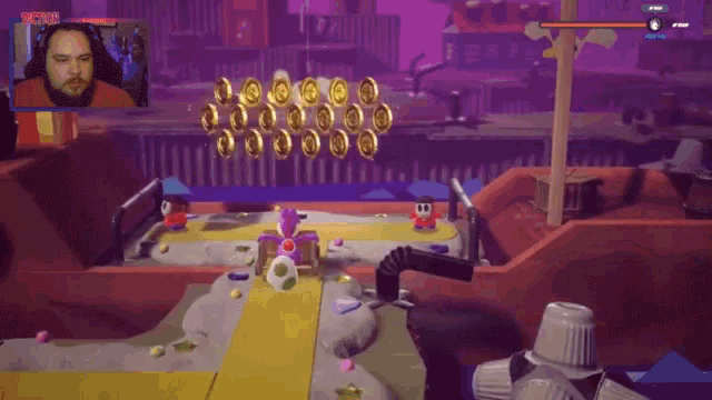 a man is playing a video game with a purple screen that says " action " on it