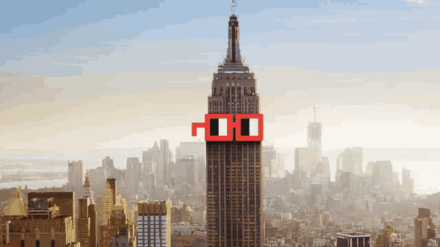 the empire state building is surrounded by a city skyline and has a pair of red glasses on the top of it