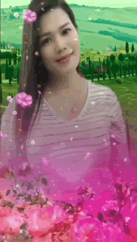 a woman in a striped shirt is surrounded by flowers