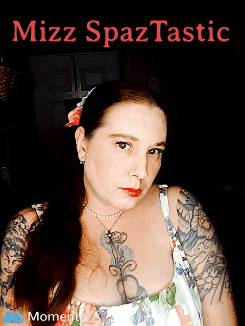 a woman with tattoos and a pearl necklace stands in front of a black background that says mizz spaztastic