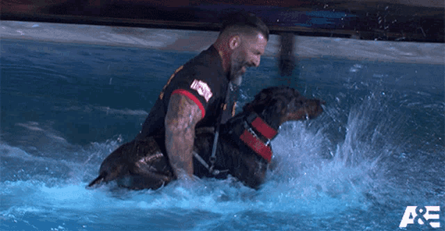 a man is riding a dog in a pool with a a & e logo in the background