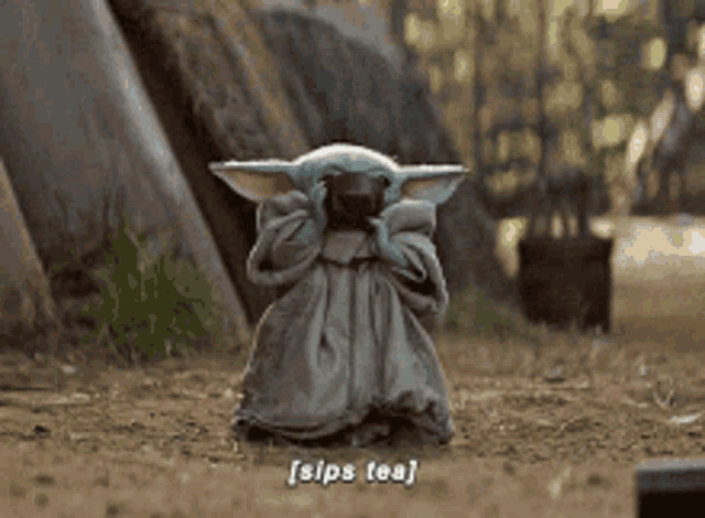 a baby yoda is drinking a cup of tea from a pot .