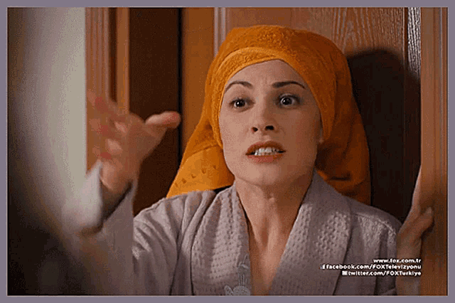 a woman with a towel wrapped around her head has facebook.com on the bottom of the image
