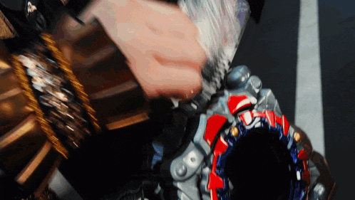 a close up of a person playing with a toy that has a red circle on it