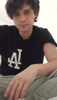 a young man is wearing a black shirt with the letter a on it