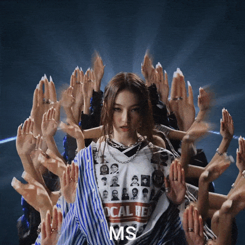 a woman wearing a shirt that says ms surrounded by hands