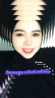 a woman in a black hijab has a tiktok sticker on her face