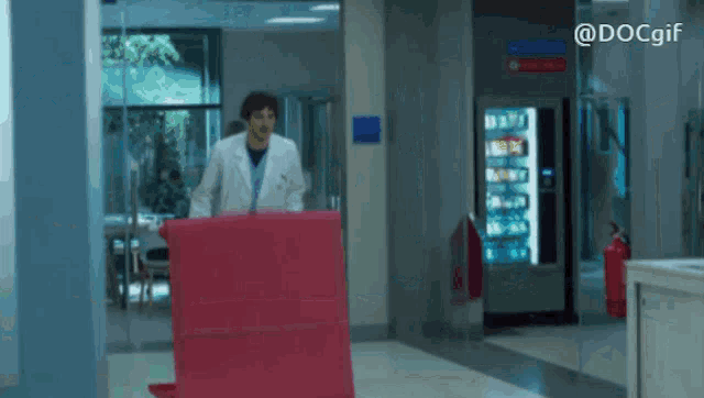 a man in a lab coat is standing in a hospital hallway