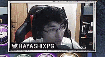a man wearing headphones and glasses is sitting in a chair with a microphone .