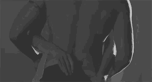 a man and a woman are kissing each other in a black and white photo .