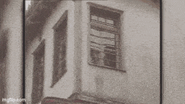 a black and white photo of a building with a window .