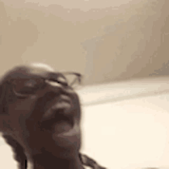 a man wearing glasses is making a funny face .