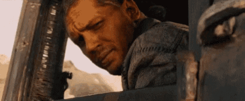 a man is looking out of the window of a truck .