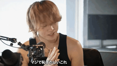 a man in front of a microphone that says j-wave