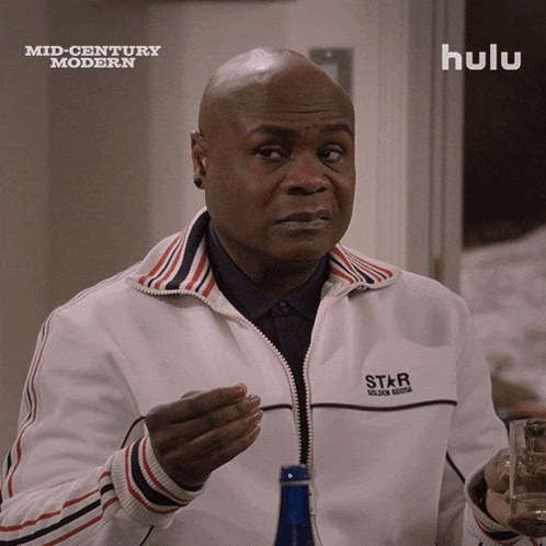 a man wearing a white jacket that says star on the back