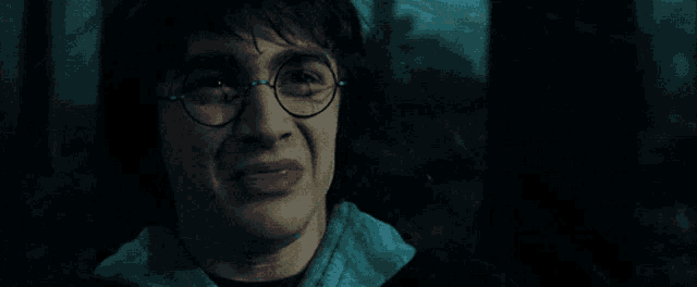 a close up of harry potter 's face with glasses