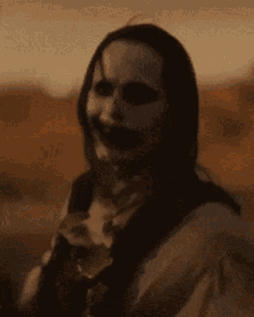 a close up of a person 's face with a scary smile .