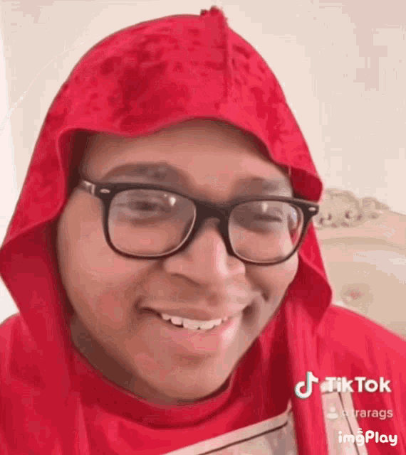 a person wearing glasses and a red hood has a tiktok account