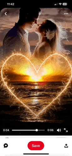 a screenshot of a video of a man and woman kissing with a heart made of sparklers in the background