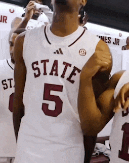a man wearing a white jersey that says state 5 on it