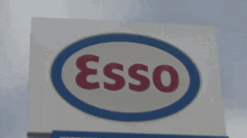 a sign that says esso go store in red letters