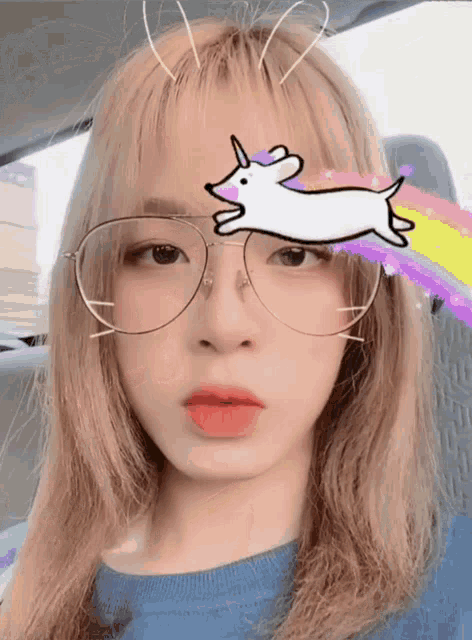 a girl wearing glasses with a unicorn on her forehead