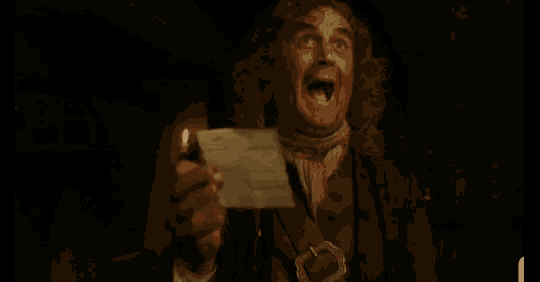 a man with curly hair is holding a piece of paper in his hand with his mouth open