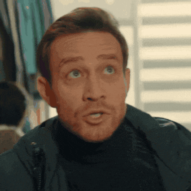 a man with a beard is wearing a black turtleneck and a leather jacket