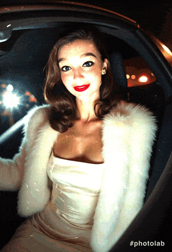 a woman in a white fur coat is sitting in a car with the hashtag #photolab