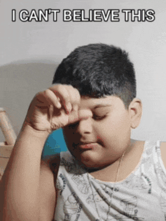 a young boy is covering his eyes with his hand and the caption i can 't believe this is above him