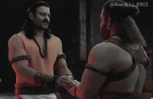 two men shaking hands with a watermark that says avantika 0902