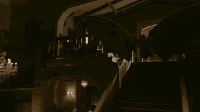 a dark room with a chandelier and a statue of a dragon