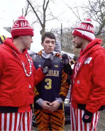 a man in a michigan jersey is being interviewed by another man
