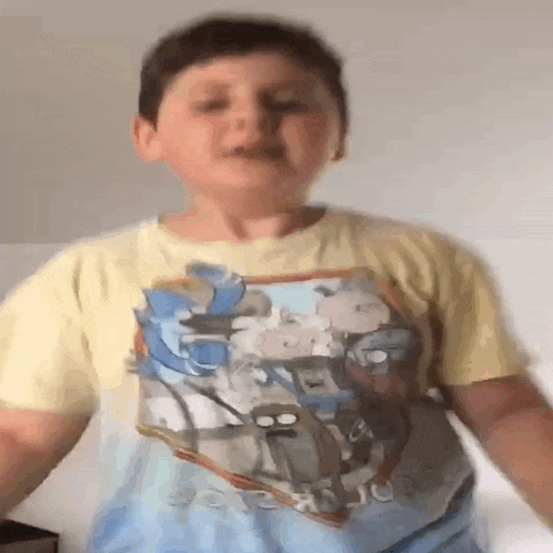 a boy wearing a regular show shirt is dancing