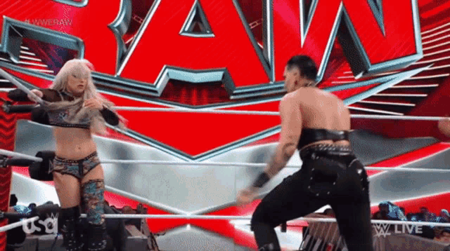 two women are wrestling in a wrestling ring with the word raw in the background
