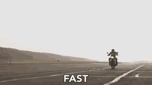 a man is riding a motorcycle down a road and the word fast is on the bottom