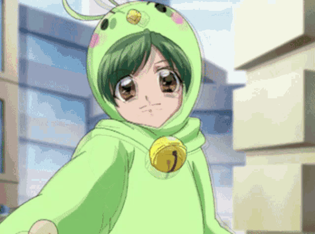 a girl with green hair is wearing a green hoodie with a bell around her neck