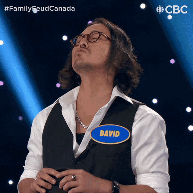 a man wearing glasses and a vest has a name tag that says david