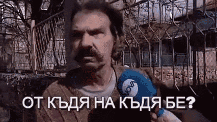 a man with a mustache is holding a microphone and asking a question .