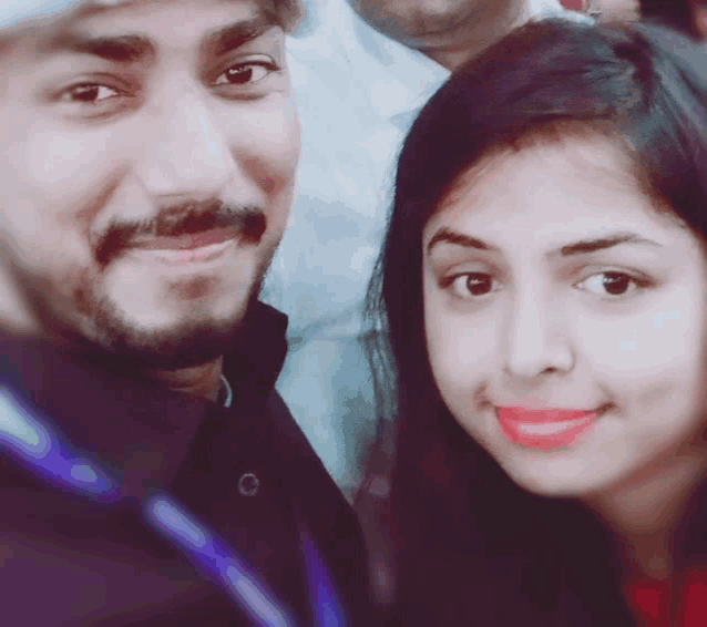 a man and woman are posing for a picture together