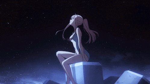 a girl in a bathing suit is sitting on a rock looking up at the sky