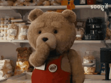 a teddy bear wearing a red apron that says help on it
