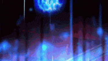 a glowing blue object is hanging from a string in the dark