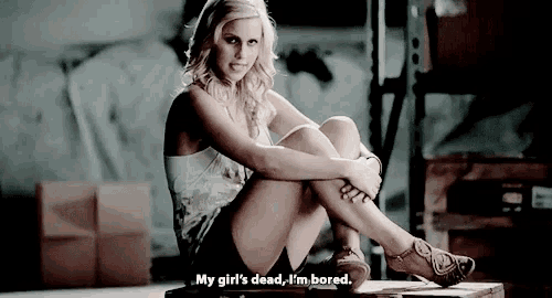 a woman is sitting on a wooden box and says " my girl 's dead i 'm bored "