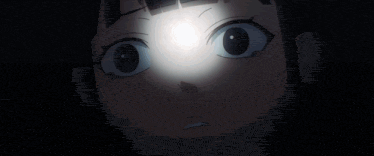 a close up of a girl 's face with a light shining on it