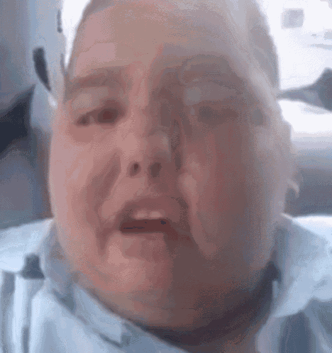 a close up of a fat boy making a funny face while sitting in a car .