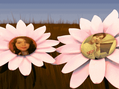 two pink daisies with a picture of a woman in the center and a sticker that says ' i love you ' on it