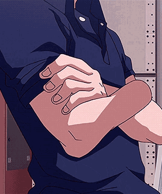 a man in a blue shirt has his arms crossed and his fingers are crossed as well